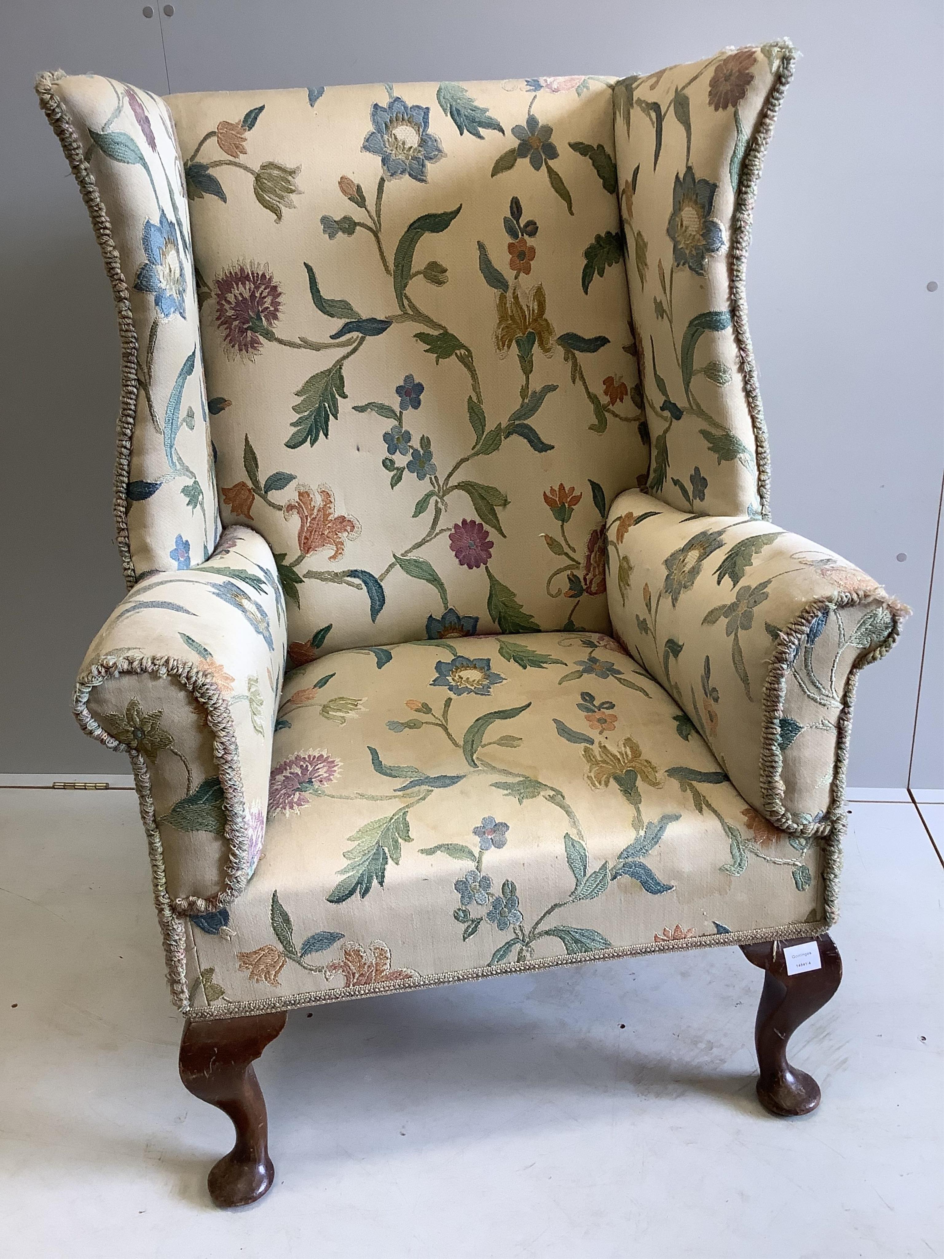 A George I style upholstered wing back armchair, width 79cm, depth 70cm, height 120cm. Condition - fair